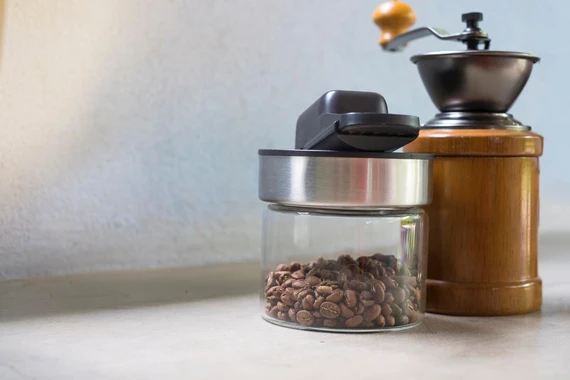 Opened coffee bag with vacuum seal and fresh espresso beans