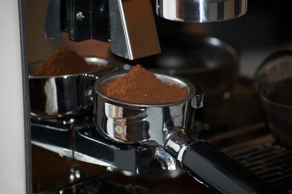 Freshly ground espresso coffee dose from burr grinder