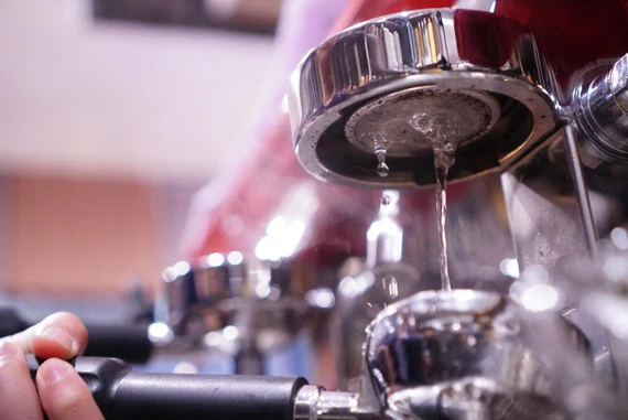Filtered water being added to espresso machine water reservoir