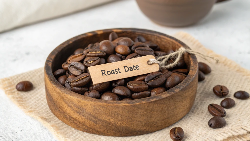 Coffee bag showing roast date with fresh whole beans