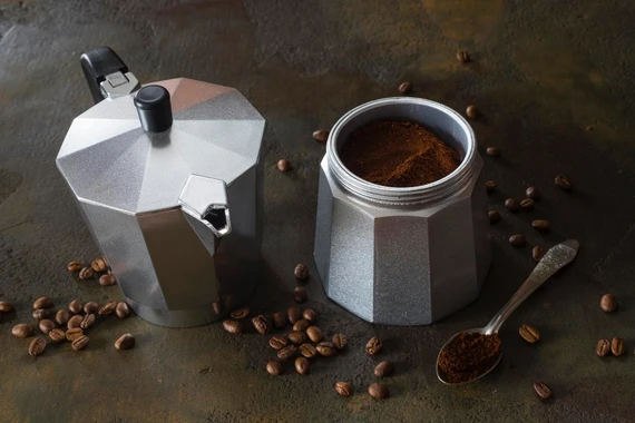 Moka pot disassembled showing three chambers and filter basket