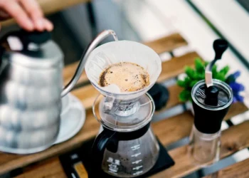 Pour over coffee brewing with hot water being poured over grounds in dripper