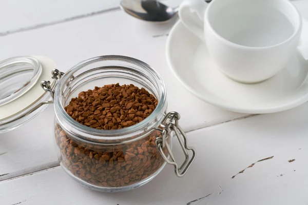 Instant coffee jar and cup showing convenient coffee preparation
