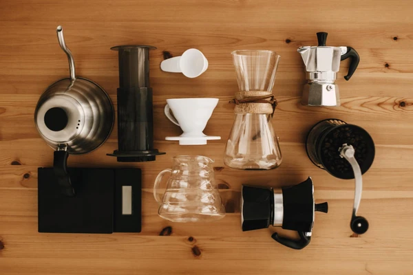 Various modern coffee brewing equipment including espresso machine, pour over, French press
