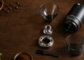 Labeled coffee grinder parts including burrs, hopper, and grind adjustment collar